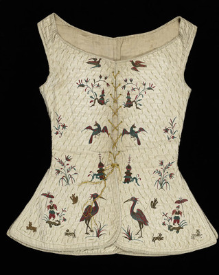 Textiles. Underbodice. Cream linen, the upper part padded and lined with cream linen, the fronts and skirt lined with cream silk. The edges are bound with silk ribbon. Embroidered, with the exception of the upper part of the back, in puce, green, brown and cream silk threads in satin and chain stitches with chinoiserie and animal motifs against a backgound seme with slender leaves. The bodice has narrow shoulders and a wide neckline, lower at the front than at the back. The fronts curve in at the waist and are rounded at the lower edge. There are a back and side vents. The bodice fastens down the front by means of eight pairs of eyelet holes and a dark yellow silk cord. Length, back, 23 in, circa 1700- circa 1749. English.